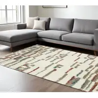 Photo of Tan Gray And Ivory Abstract Shag Distressed Area Rug With Fringe