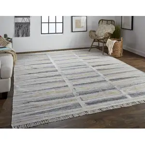 Photo of Tan Gray And Taupe Geometric Hand Woven Stain Resistant Area Rug With Fringe