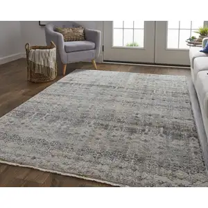 Photo of Tan Ivory And Blue Geometric Power Loom Distressed Area Rug With Fringe