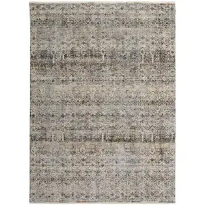 Photo of Tan Ivory And Blue Geometric Power Loom Distressed Area Rug With Fringe