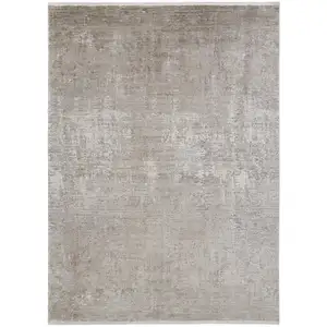 Photo of Tan Ivory And Gray Abstract Power Loom Distressed Area Rug With Fringe