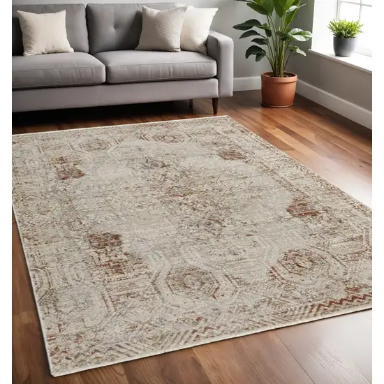 Tan and Ivory Floral Power Loom Distressed Non Skid Area Rug With Fringe Photo 1