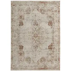 Photo of Tan Ivory And Orange Floral Power Loom Distressed Area Rug With Fringe