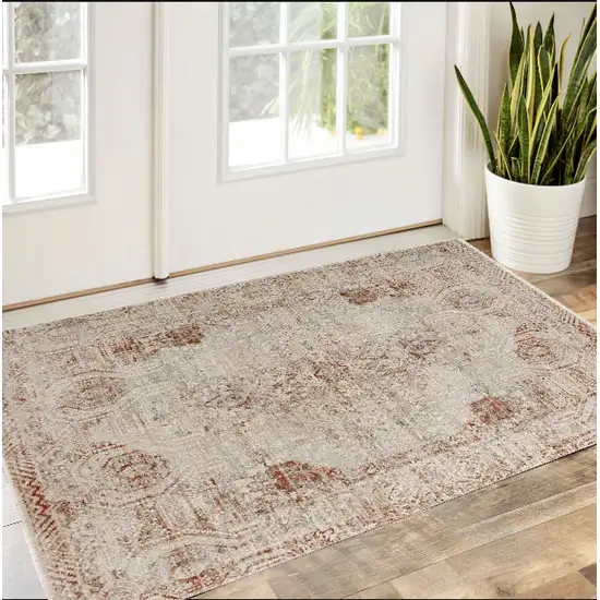 Tan Ivory And Orange Floral Power Loom Distressed Area Rug With Fringe Photo 1