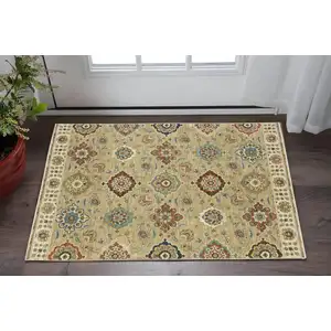 Photo of Tan Light Blue And Orange Floral Area Rug With Fringe