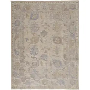 Photo of Tan Orange And Blue Floral Hand Knotted Stain Resistant Area Rug