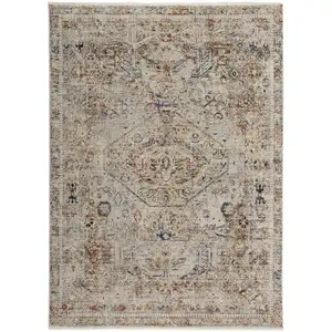 Photo of Tan Orange And Red Floral Power Loom Distressed Area Rug With Fringe