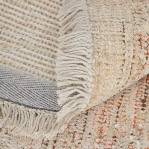 Photo of Tan Orange and Ivory Oriental Hand Woven Distressed Area Rug With Fringe