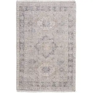 Photo of Tan and Gray Oriental Hand Woven Distressed Area Rug With Fringe