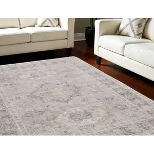 Photo of Tan and Gray Oriental Hand Woven Distressed Area Rug With Fringe