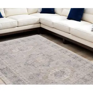 Photo of Tan and Gray Oriental Hand Woven Distressed Area Rug With Fringe