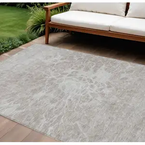 Photo of Taupe Beige And Ivory Abstract Washable Indoor Outdoor Area Rug