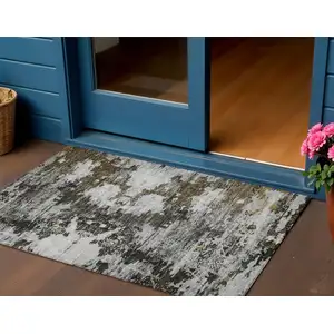 Photo of Taupe Brown And Gold Abstract Washable Indoor Outdoor Area Rug