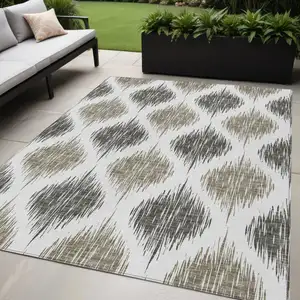 Photo of Taupe Ivory And Brown Ikat Washable Indoor Outdoor Area Rug