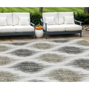 Photo of Taupe Ivory And Brown Ikat Washable Indoor Outdoor Area Rug