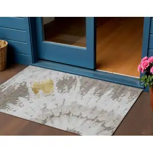 Photo of Taupe Khaki And Ivory Abstract Washable Indoor Outdoor Area Rug