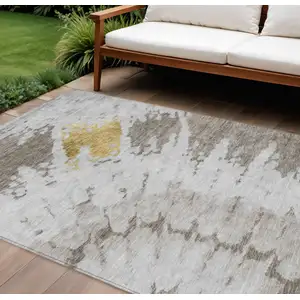 Photo of Taupe Khaki And Ivory Abstract Washable Indoor Outdoor Area Rug