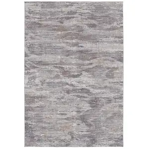 Photo of Taupe Tan And Orange Abstract Power Loom Distressed Stain Resistant Area Rug