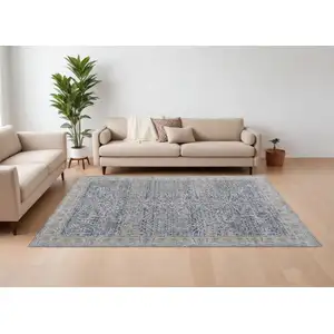 Photo of Taupe and Blue Ikat Power Loom Worn Faded Area Rug With Fringe