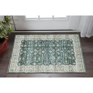 Photo of Teal And Ivory Oriental Distressed Area Rug