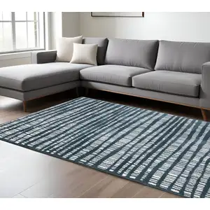 Photo of Teal And Ivory Striped Distressed Area Rug