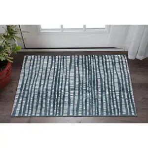 Photo of Teal And Ivory Striped Distressed Area Rug