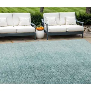 Photo of Teal Blue And Aqua Abstract Washable Indoor Outdoor Area Rug