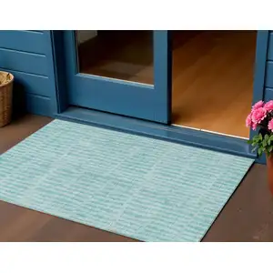 Photo of Teal Blue And Aqua Striped Washable Indoor Outdoor Area Rug