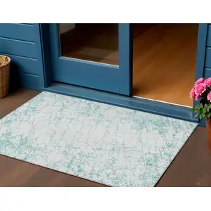 Photo of Teal Blue And Ivory Abstract Washable Indoor Outdoor Area Rug