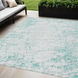 Photo of Teal Blue And Ivory Abstract Washable Indoor Outdoor Area Rug