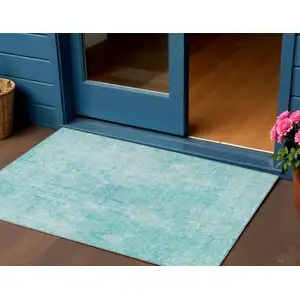 Photo of Teal Blue And Ivory Abstract Washable Indoor Outdoor Area Rug