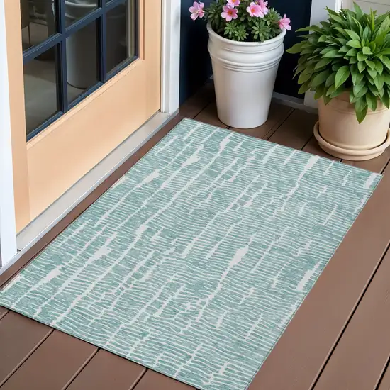 Teal Blue And Ivory Abstract Washable Indoor Outdoor Area Rug Photo 1