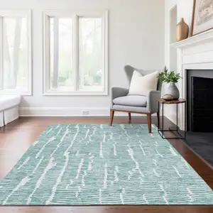 Photo of Teal Blue And Ivory Abstract Washable Indoor Outdoor Area Rug