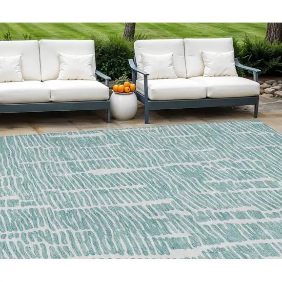 Teal Blue And Ivory Abstract Washable Indoor Outdoor Area Rug Photo 1