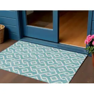 Photo of Teal Blue And Ivory Geometric Washable Indoor Outdoor Area Rug