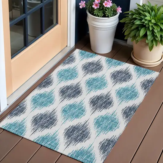 Teal Blue And Ivory Ikat Washable Indoor Outdoor Area Rug Photo 1