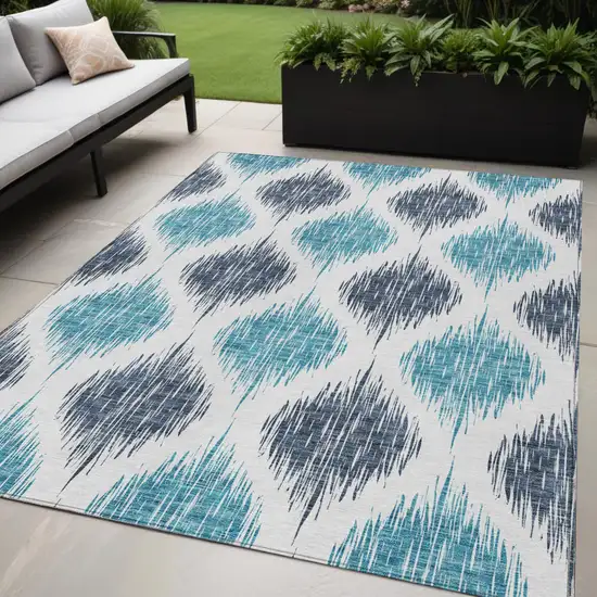 Teal Blue And Ivory Ikat Washable Indoor Outdoor Area Rug Photo 1