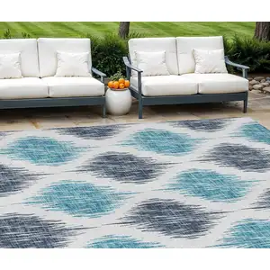 Photo of Teal Blue And Ivory Ikat Washable Indoor Outdoor Area Rug