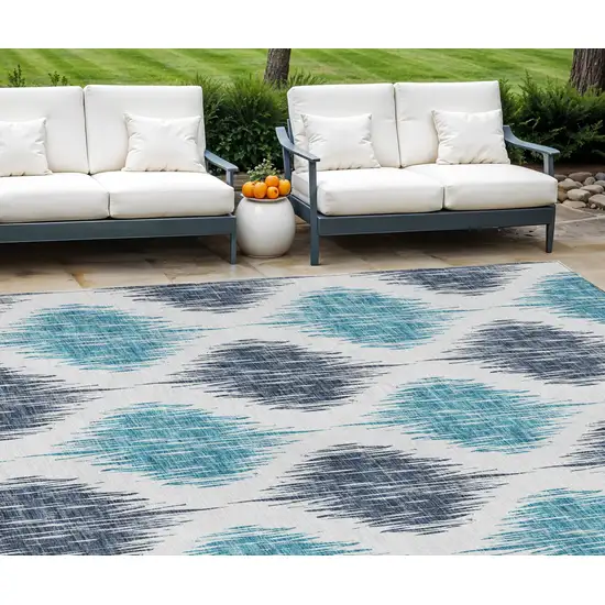 Teal Blue And Ivory Ikat Washable Indoor Outdoor Area Rug Photo 1