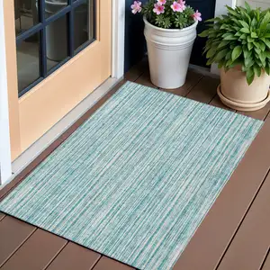 Photo of Teal Blue And Ivory Striped Washable Indoor Outdoor Area Rug