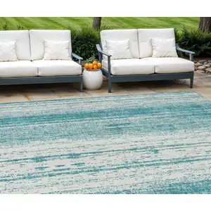 Photo of Teal Blue And Ivory Striped Washable Indoor Outdoor Area Rug