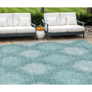 Photo of Teal Blue And Mint Green Ikat Washable Indoor Outdoor Area Rug