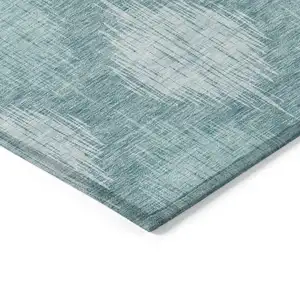 Photo of Teal Blue And Mint Green Ikat Washable Indoor Outdoor Area Rug