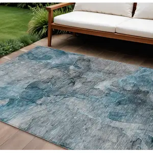 Photo of Teal Blue And Navy Blue Abstract Washable Indoor Outdoor Area Rug