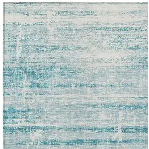 Photo of Teal Blue Aqua And Ivory Abstract Washable Indoor Outdoor Area Rug