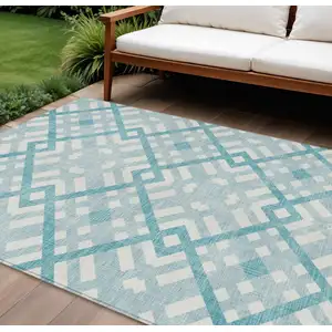 Photo of Teal Blue Aqua And Ivory Geometric Washable Indoor Outdoor Area Rug