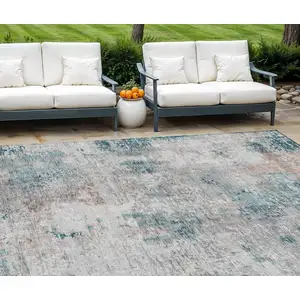 Photo of Teal Blue Beige And Copper Abstract Washable Indoor Outdoor Area Rug