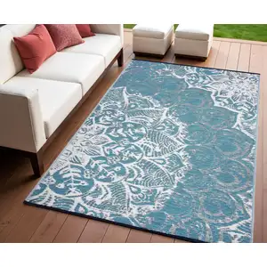 Photo of Teal Blue Floral Machine Braided Distressed Area Rug With UV Protection