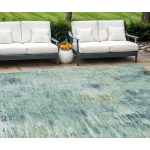 Photo of Teal Blue Green And Ivory Abstract Washable Indoor Outdoor Area Rug