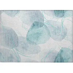 Photo of Teal and Ivory Abstract Washable Non Skid Indoor Outdoor Area Rug